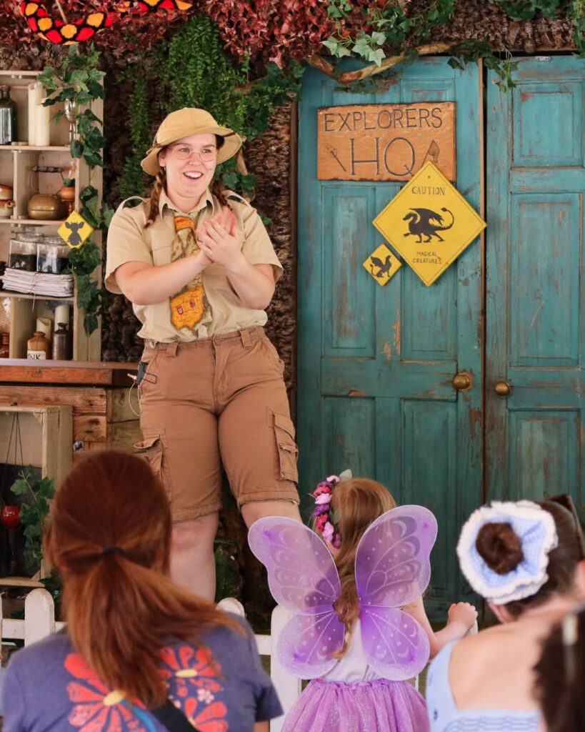 Children enjoying live interactive entertainment with an explorer character at Audley End Enchanted Railway's Summer Festival.