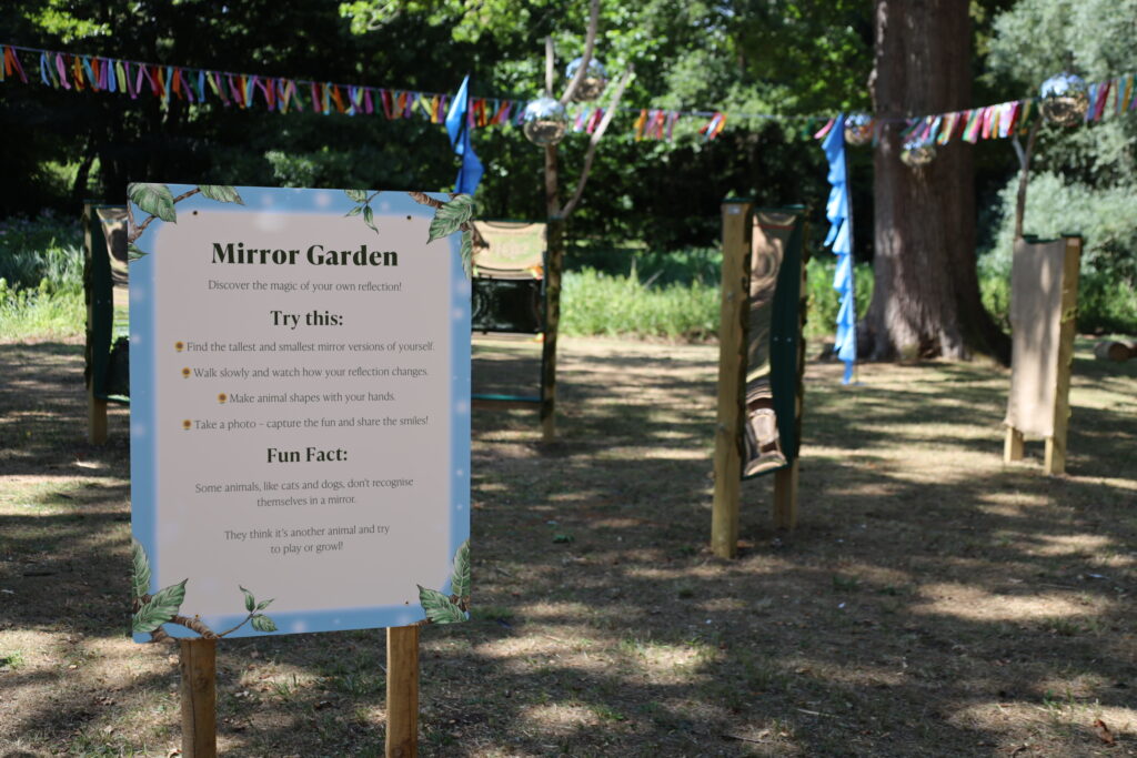 Mirror Garden sensory attraction at Audley End Enchanted Railway's Summer Festival, featuring funhouse mirrors in a woodland setting.