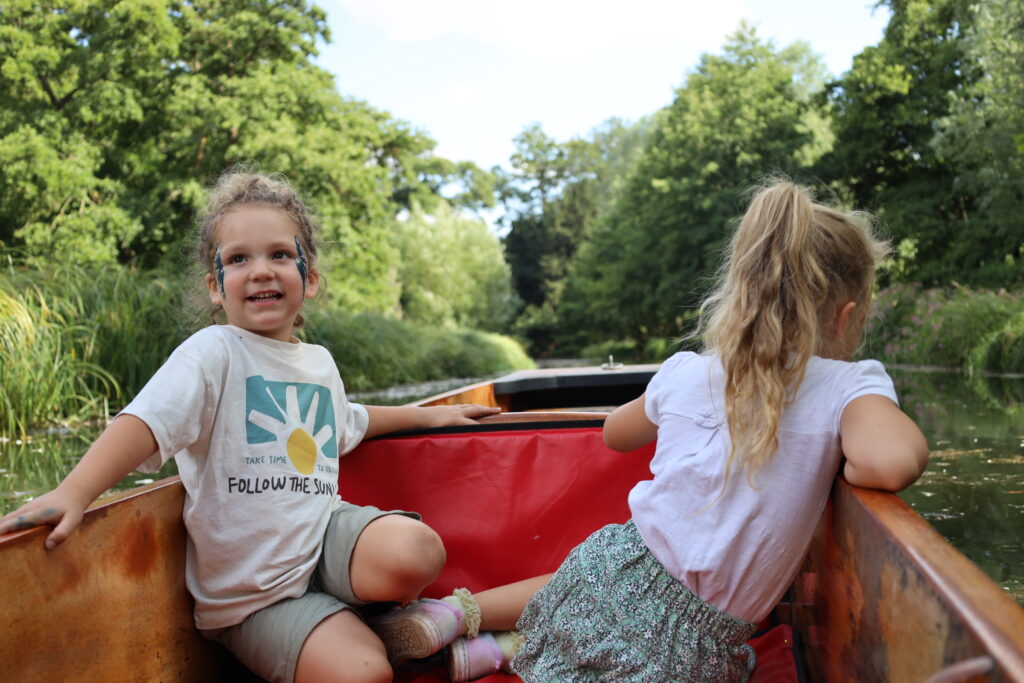 Children enjoying a punt boat ride through the woodland at Audley End Enchanted Railway during the Summer Festival.