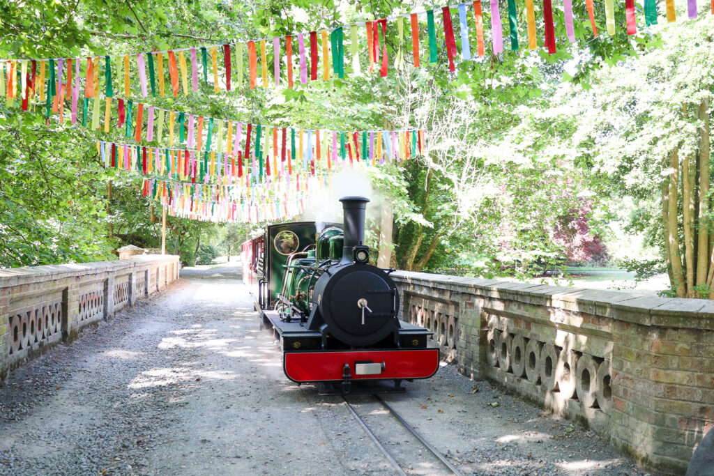 Train riding over bridge for Summer Festival at Audley End Enchanted Railway