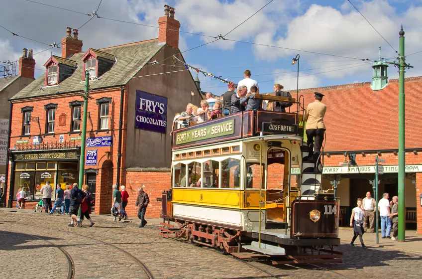 Family riding a historic tram at Beamish Museum, County Durham